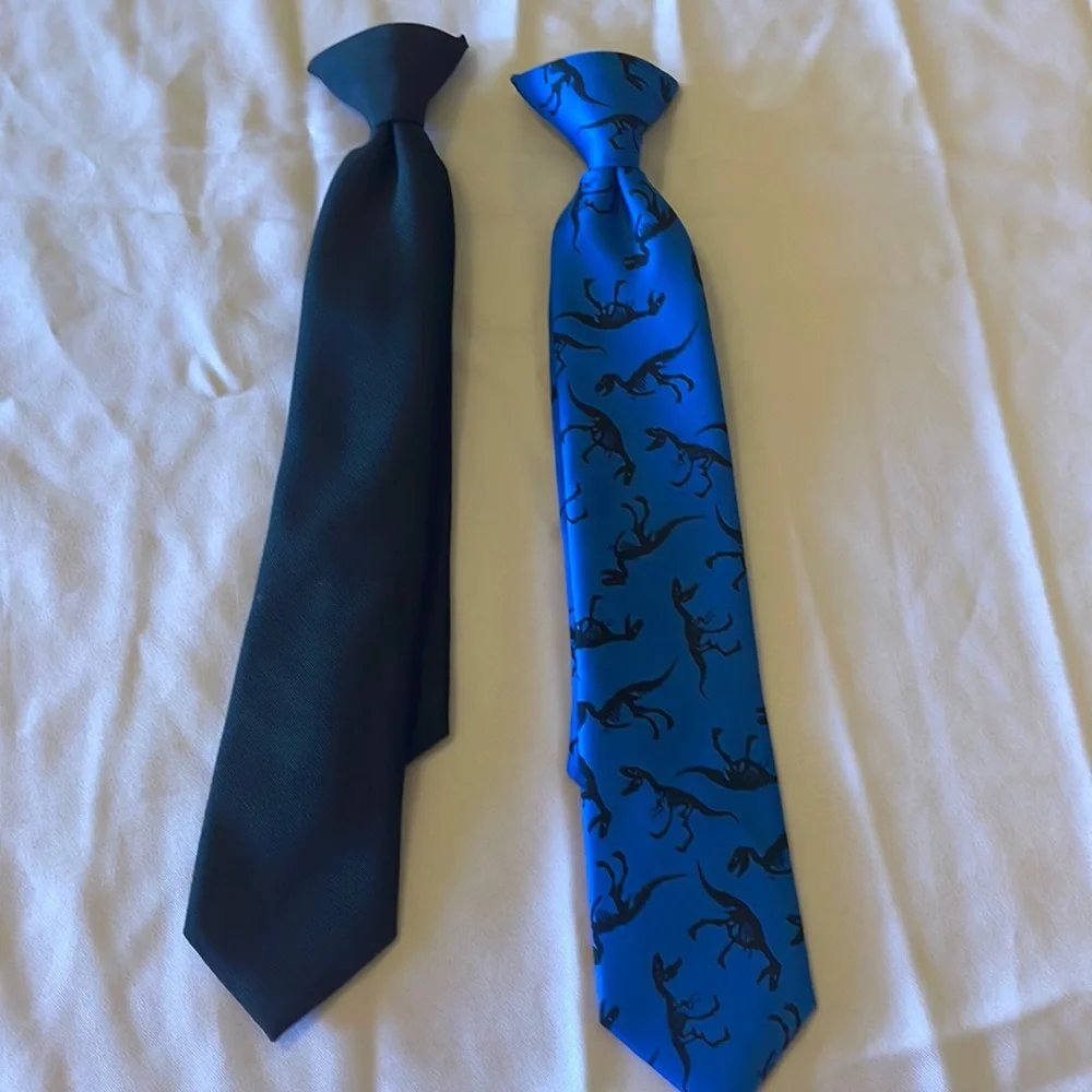 2 clip on ties. One black, one blue with dinosaurs. Very cute. Boys size 6-8